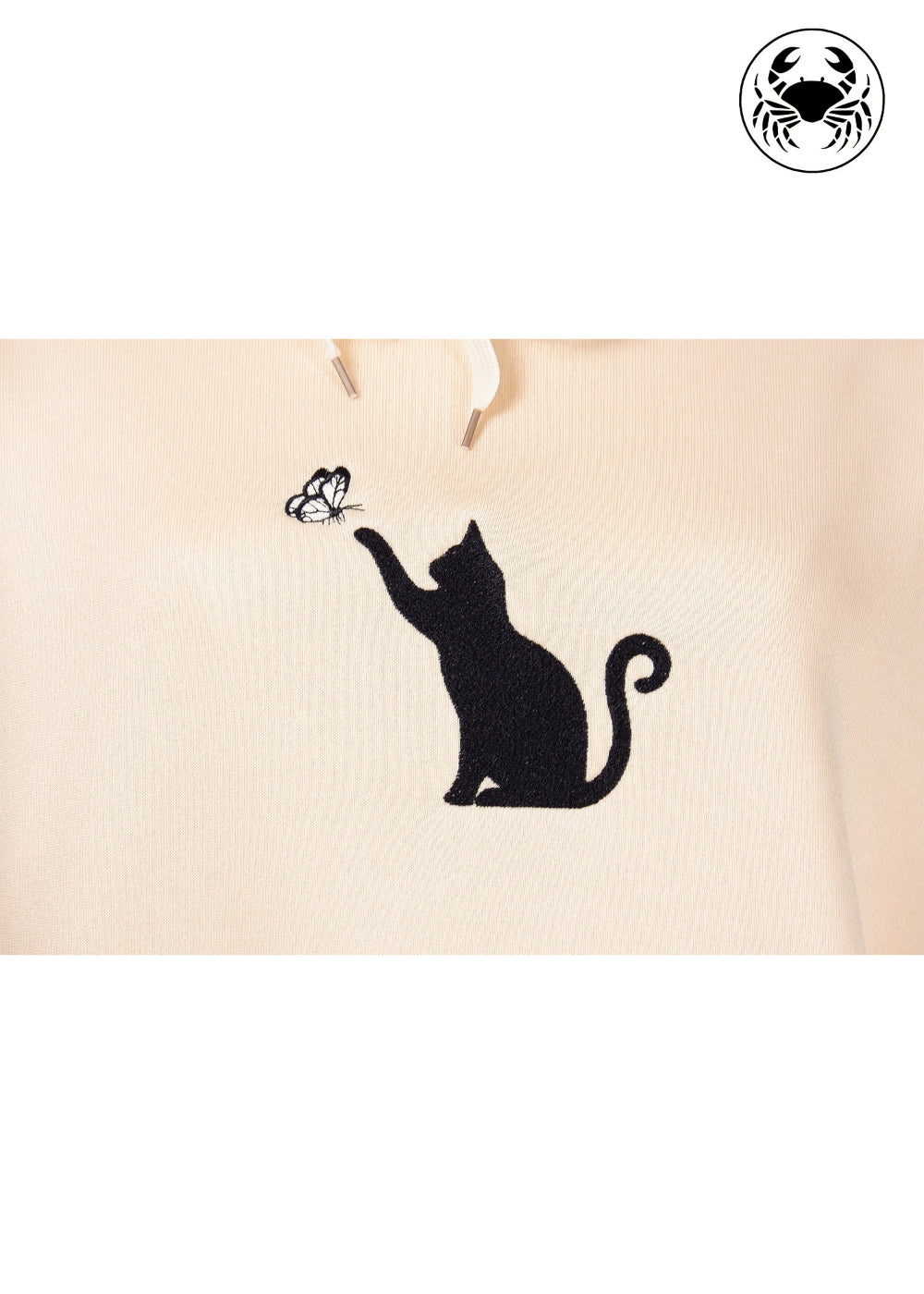Unisex light beige hoodie with a front kangaroo pocket, drawstring hood, and an embroidered chest design featuring a black Cat Caught in a Moment with Butterfly