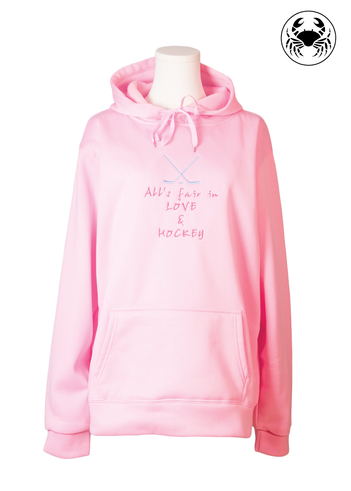 Pink embroidered hoodie with hockey sticks and “All Is Fair in Love and Hockey” design, Canadian apparel, unisex fit